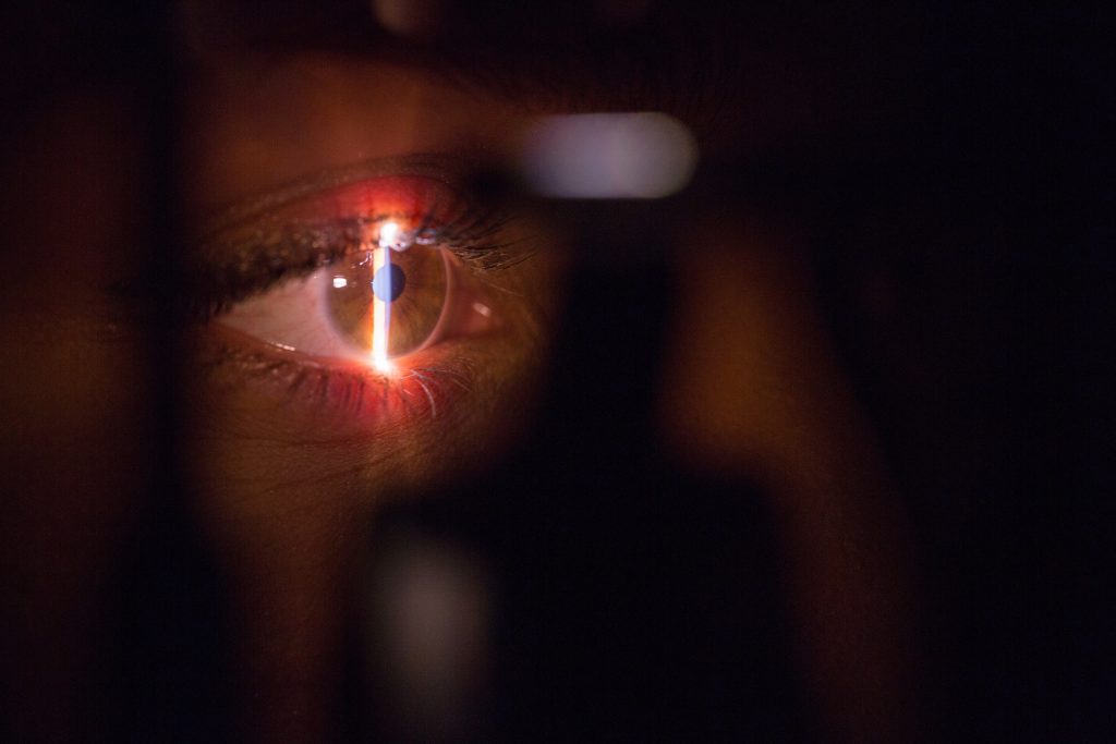A medical laser shines into an eye