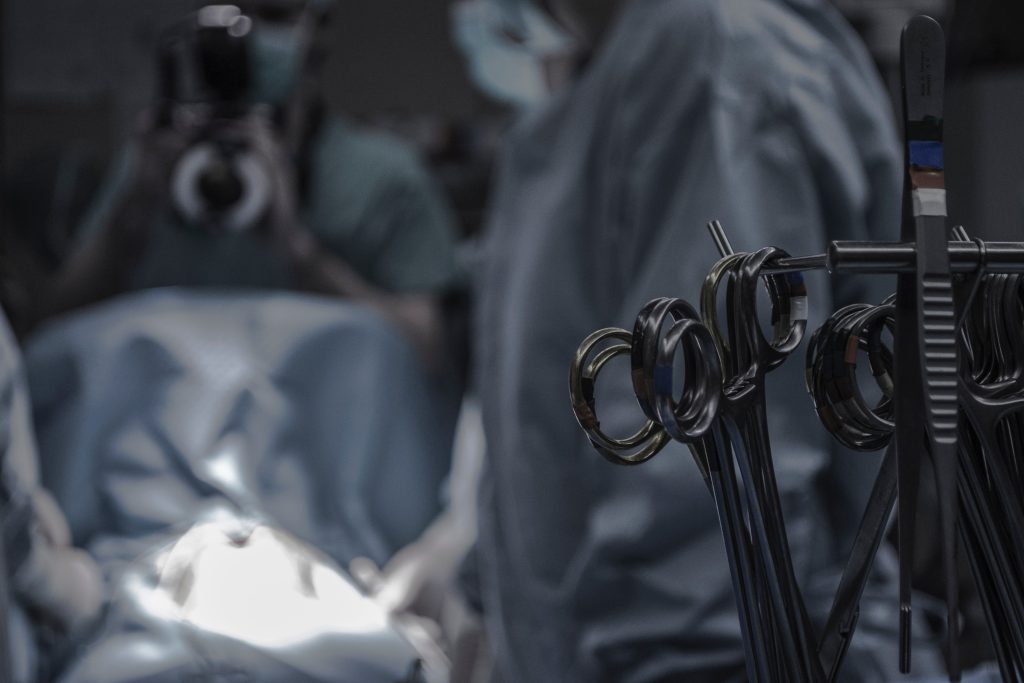 A close up of medical instruments with surgeons in the background