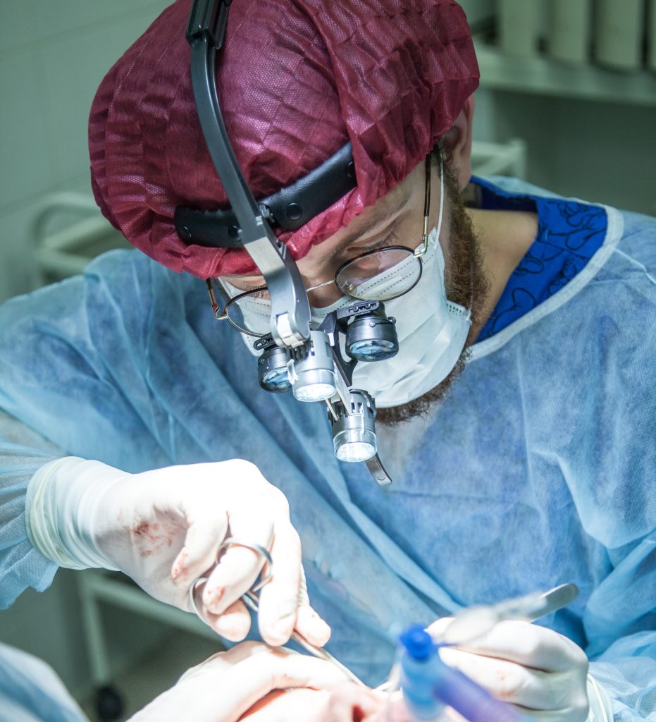 A doctor performs surgery on a patient's eye